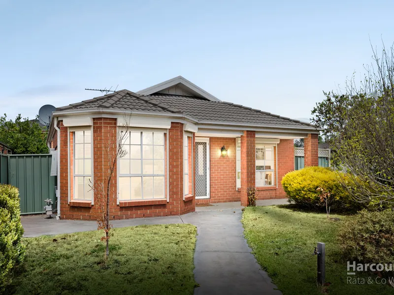 Front exterior of a single-story brick unit with a pathway and garden, listed by Nathan Hunt Real Estate.